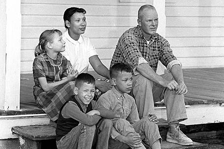 Richard and Mildred Loving sitting on a porch with their three children